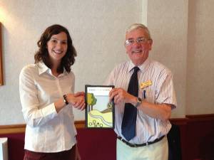 Laura shows her home Rotary Club banner to President Jimmy